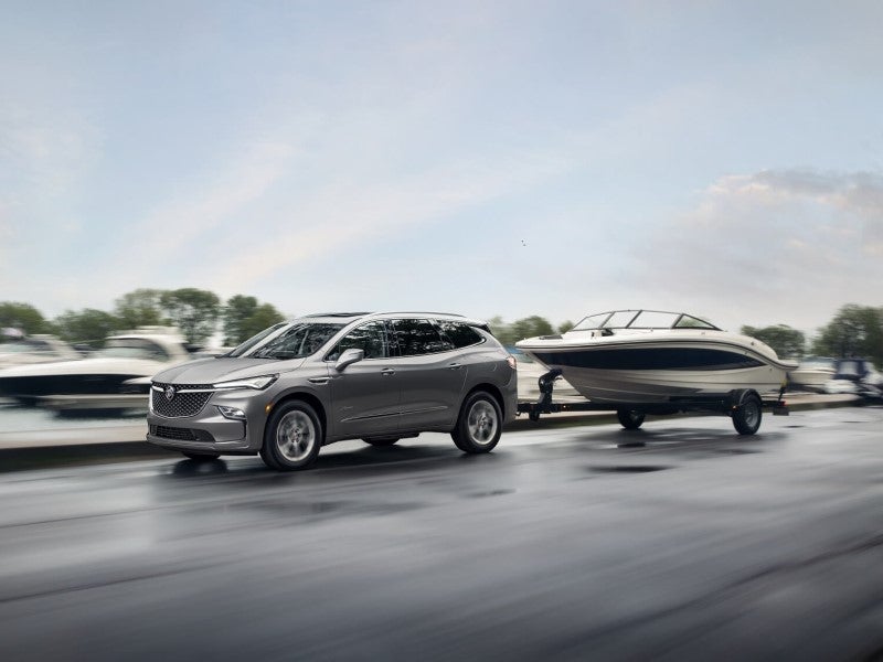 Silver Buick Enclave towing a boat